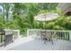 Enjoy outdoor dining on this patio with an umbrella-covered table and lush greenery at 205 Plantation Sw Rd, Smyrna, GA 30082