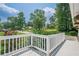 A beautiful porch overlooks a garden and lush green lawn at 205 Plantation Sw Rd, Smyrna, GA 30082