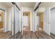 Bright hallway with multiple entrances and doorways, featuring modern wood floors at 361 17Th St # 2120, Atlanta, GA 30363