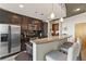 This modern kitchen features stainless steel appliances, dark wood cabinets, and a granite-topped breakfast bar at 361 17Th St # 2120, Atlanta, GA 30363