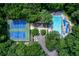 Aerial view of a community tennis club and swimming pool surrounded by lush trees at 1183 Woods Ne Cir, Atlanta, GA 30324