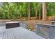 Backyard deck features a relaxing hot tub, surrounded by lush trees, and a privacy fence at 1183 Woods Ne Cir, Atlanta, GA 30324