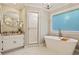 Luxurious bathroom features a soaking tub, frameless shower, and elegant vanity with granite countertops at 1183 Woods Ne Cir, Atlanta, GA 30324