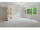 Bright bedroom features a neutral carpet, large windows, and white trim at 1183 Woods Ne Cir, Atlanta, GA 30324