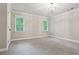 Bedroom with neutral carpet, base-molding, two windows with treed views at 1183 Woods Ne Cir, Atlanta, GA 30324