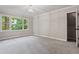 Light-filled bedroom features a neutral carpet, large windows, and white trim at 1183 Woods Ne Cir, Atlanta, GA 30324