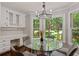 Sun-filled breakfast nook with large windows overlooking the lush landscaped backyard and built-in desk at 1183 Woods Ne Cir, Atlanta, GA 30324
