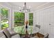 Bright breakfast nook with floor-to-ceiling windows and view of the landscaped backyard at 1183 Woods Ne Cir, Atlanta, GA 30324