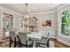 Inviting dining room with natural light, elegant chandelier, and staircase access at 1183 Woods Ne Cir, Atlanta, GA 30324
