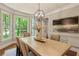 Bright dining room features an elegant light fixture and bay window offering beautiful outdoor views at 1183 Woods Ne Cir, Atlanta, GA 30324