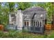 Back exterior featuring a deck, patio, and mature landscaping at 1183 Woods Ne Cir, Atlanta, GA 30324