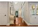 Elegant foyer with hardwood floors, stylish console table, chandelier and front door view at 1183 Woods Ne Cir, Atlanta, GA 30324
