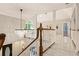 Upstairs hallway featuring marble floors, a chandelier, and views to the downstairs foyer at 1183 Woods Ne Cir, Atlanta, GA 30324