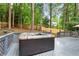 Backyard deck features a relaxing hot tub, perfect for outdoor entertaining with lush trees, and privacy fence at 1183 Woods Ne Cir, Atlanta, GA 30324