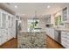 Bright, updated kitchen featuring a large island with striking granite and stainless steel appliances at 1183 Woods Ne Cir, Atlanta, GA 30324