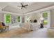 Spacious primary bedroom boasts tray ceilings, large windows, and plush carpeting at 1183 Woods Ne Cir, Atlanta, GA 30324