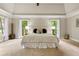 Serene primary bedroom with tray ceilings and dual windows offers bright, natural light at 1183 Woods Ne Cir, Atlanta, GA 30324