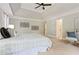 Spacious primary bedroom boasts tray ceilings, plush carpeting, and access to en suite bathroom at 1183 Woods Ne Cir, Atlanta, GA 30324
