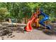 A vibrant playground features colorful slides, climbing structures, and ample space for children to play at 1183 Woods Ne Cir, Atlanta, GA 30324