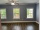 Bedroom with beautiful hardwood flooring, gray walls, and natural light at 1462 Knights Trl, Stone Mountain, GA 30083