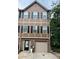 Two-story townhouse with brown and tan exterior and a single car garage at 1462 Knights Trl, Stone Mountain, GA 30083