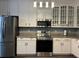 Bright kitchen with stainless steel appliances and white cabinetry at 1462 Knights Trl, Stone Mountain, GA 30083