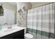 Bathroom featuring a vanity, toilet, and shower with a decorative shower curtain at 3909 Obryant Se Cir, Smyrna, GA 30082