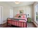 Cozy bedroom featuring hardwood floors, a bed with patterned linens, and a window for natural light at 3909 Obryant Se Cir, Smyrna, GA 30082