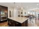 Open kitchen with a center island, dark wood cabinets, and a view of the adjacent living room at 3909 Obryant Se Cir, Smyrna, GA 30082