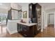 Kitchenette area adjacent to stairs with dark wood cabinets and stainless oven at 3909 Obryant Se Cir, Smyrna, GA 30082