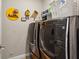 Modern laundry room with updated washer and dryer units and decorative wall fixtures at 3909 Obryant Se Cir, Smyrna, GA 30082