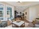 Bright living room open to kitchen featuring hardwood floors, large windows and modern decor at 3909 Obryant Se Cir, Smyrna, GA 30082