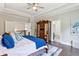 Bright main bedroom featuring a ceiling fan, wooden floors, and a decorative wardrobe at 3909 Obryant Se Cir, Smyrna, GA 30082