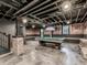 Basement pool table room with painted brick walls, exposed ductwork, and stairs leading to another level at 646 Darlington Ne Cir, Atlanta, GA 30305