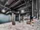Finished basement area featuring painted ceilings, exposed ductwork, brick pillars, and additional entertainment space at 646 Darlington Ne Cir, Atlanta, GA 30305