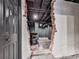 Exposed brick opening in the basement reveals finished area with painted ceiling and walls, door, and concrete flooring at 646 Darlington Ne Cir, Atlanta, GA 30305