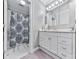Bathroom featuring a white vanity with a marble countertop and a shower-tub combination with a decorative shower curtain at 646 Darlington Ne Cir, Atlanta, GA 30305