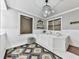 Bright bathroom with a large soaking tub, decorative chandelier, and wainscoting detail at 646 Darlington Ne Cir, Atlanta, GA 30305