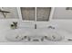 A close up of a large white soaking tub with chrome fixtures and a tiled surround at 646 Darlington Ne Cir, Atlanta, GA 30305