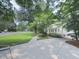 Well-maintained home featuring a spacious driveway, green lawn, and mature landscaping at 646 Darlington Ne Cir, Atlanta, GA 30305