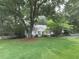Traditional home with white picket fence and a spacious lawn, surrounded by mature trees and landscaping at 646 Darlington Ne Cir, Atlanta, GA 30305