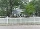 Charming home with white picket fence, lush landscaping, and inviting front porch at 646 Darlington Ne Cir, Atlanta, GA 30305