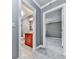 Hallway view of a bathroom with a cherry wood vanity and a bedroom with light gray walls and plush gray carpet at 646 Darlington Ne Cir, Atlanta, GA 30305