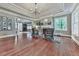 Elegant living room featuring hardwood floors, tray ceiling, fireplace and large windows offering natural light at 646 Darlington Ne Cir, Atlanta, GA 30305