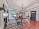 Inviting living room featuring hardwood floors, fireplace, elegant light fixture, and seamless entry to the foyer at 646 Darlington Ne Cir, Atlanta, GA 30305