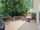 Spacious outdoor patio featuring comfortable seating, wood railings, and a serene view of the yard at 646 Darlington Ne Cir, Atlanta, GA 30305