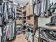 An organized walk-in closet includes rods and shelves for efficient storage with hardwood floors at 646 Darlington Ne Cir, Atlanta, GA 30305