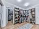 Well-organized walk-in closet with shelving, hanging rods, and hardwood flooring at 646 Darlington Ne Cir, Atlanta, GA 30305