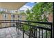 Balcony featuring tile flooring, black railing, and seating with a view of the surrounding neighborhood at 1130 Piedmont Ne Ave # 402, Atlanta, GA 30309
