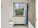 Bathroom featuring blue and white shower curtain, and a bright window with an outside view at 1130 Piedmont Ne Ave # 402, Atlanta, GA 30309